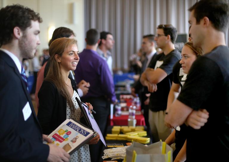 Students, alumni and employers conversing at a career fair