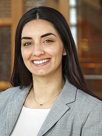 headshot of woman with long dark hair wearing a business suit admissions Assistant director