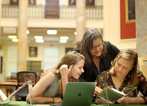 Professor of history Stephanie Yule works with two students during summer research last year.