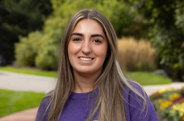 young woman in a purple Holy Cross sweatshirt