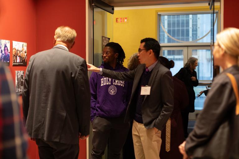 Dr. Ke Ren speaks with Holy Cross student and Mayor Joseph Petty about the Chin Family of Worcester Exhibit