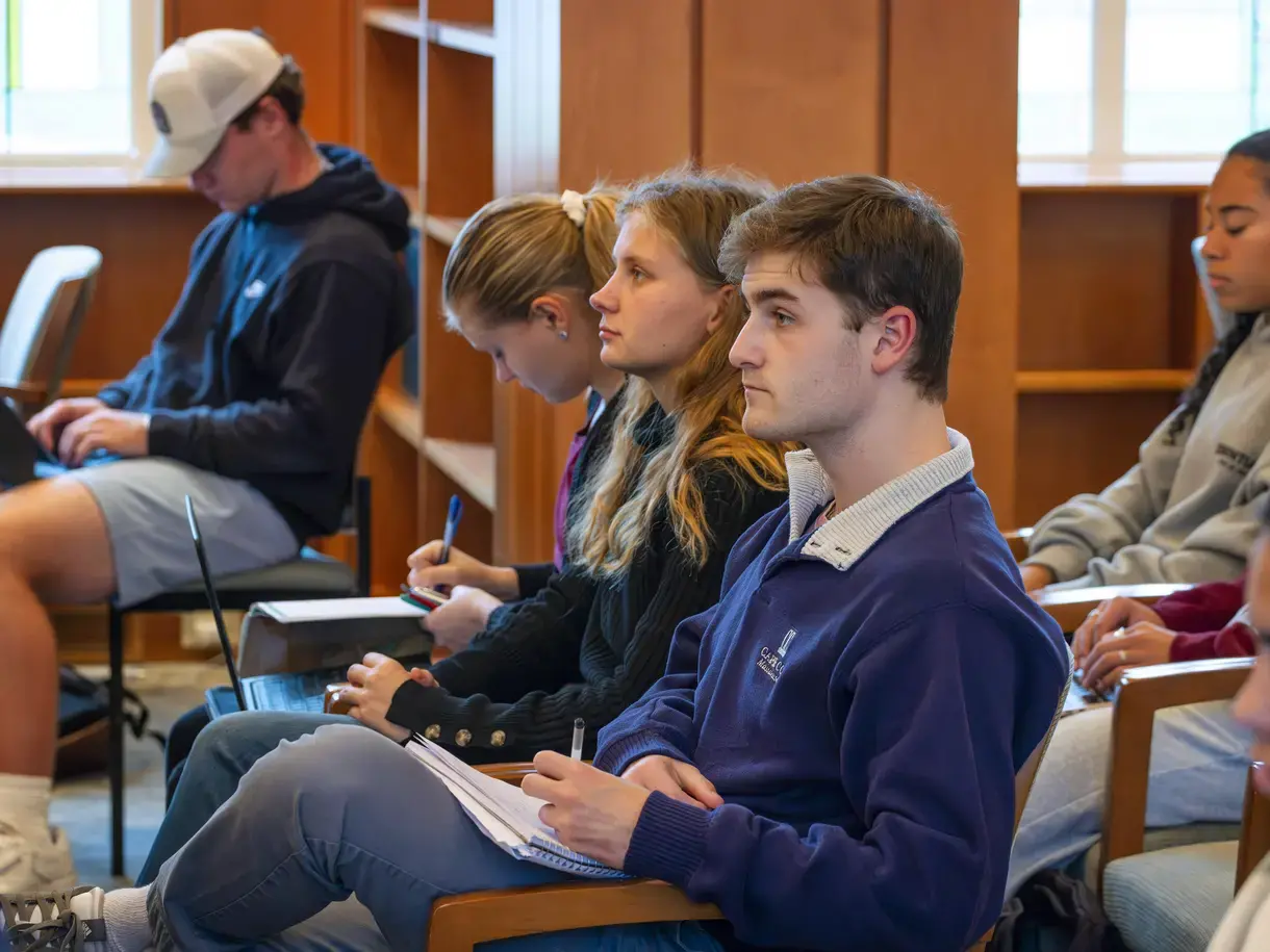 students taking notes at a forum