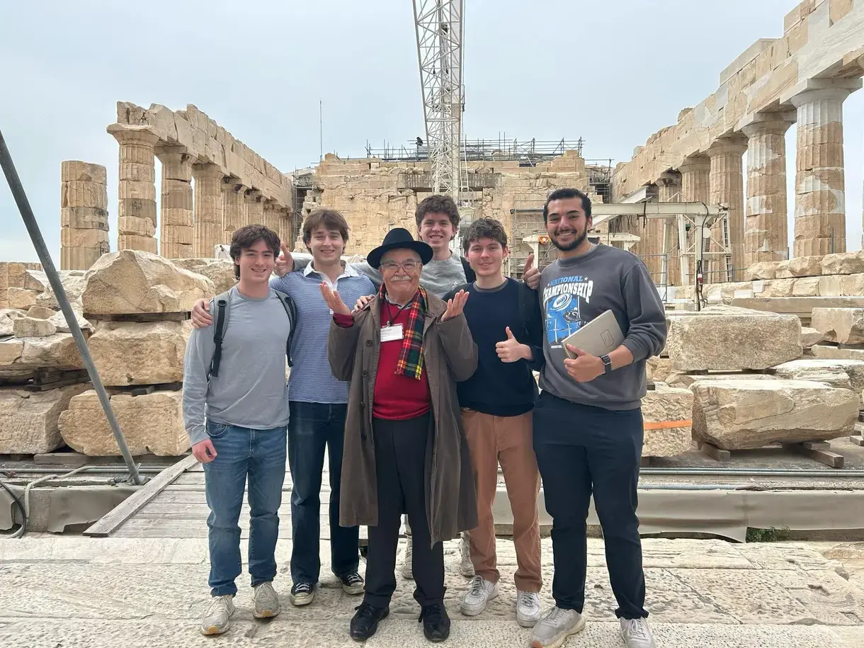 Students pose with an instructor while studying abroad