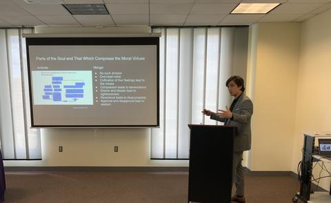 young man in a suit giving a presentation 