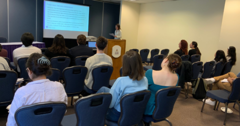 a student dressed professionally giving a presentation 