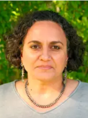 woman in a grey shirt and necklace