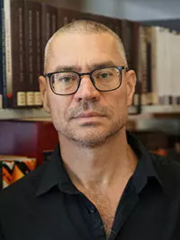 a man in a black shirt wearing glasses