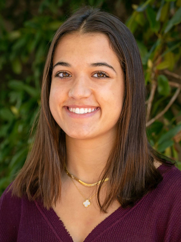 a young woman in a maroon shirt