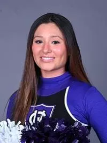 a young woman wearing a Holy Cross cheerleading uniform