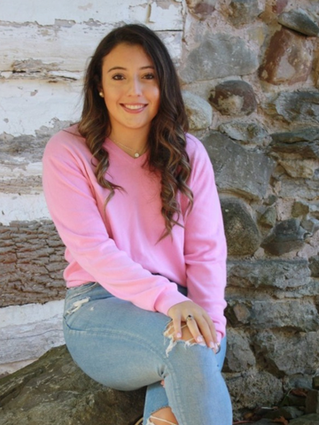 a young woman wearing a pink shirt