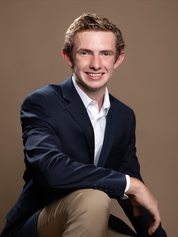 a young man in a blazer and khakis