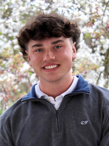 young man in front of white flowers