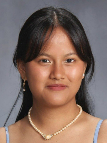 a young woman wearing a pearl necklace