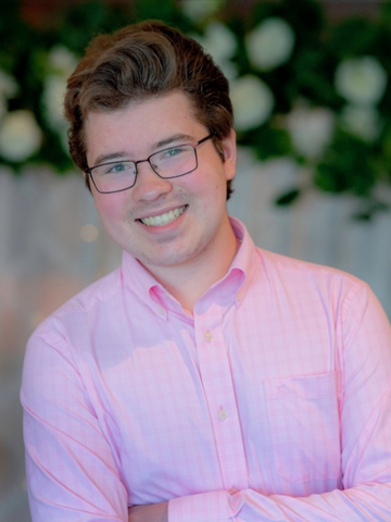 a young man in a pink button down shirt