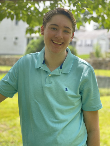 a young man in a green polo shirt