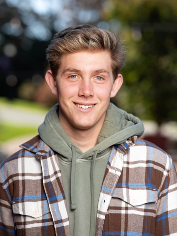 young man in a sweatshirt and flannel 