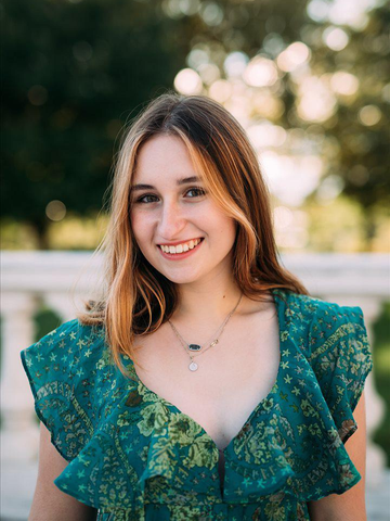 young woman wearing a green dress