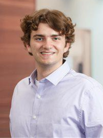 a young man in a button down shirt 