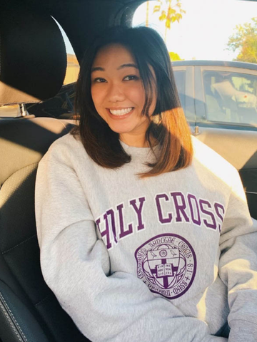 a young woman wearing a Holy Cross sweatshirt