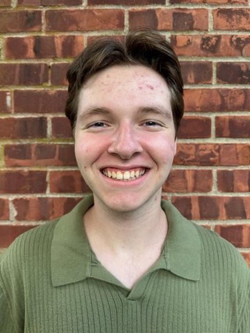 a young man in a green collared shirt