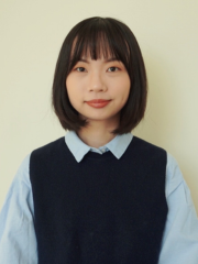 woman in vest and collared shirt looking to camera