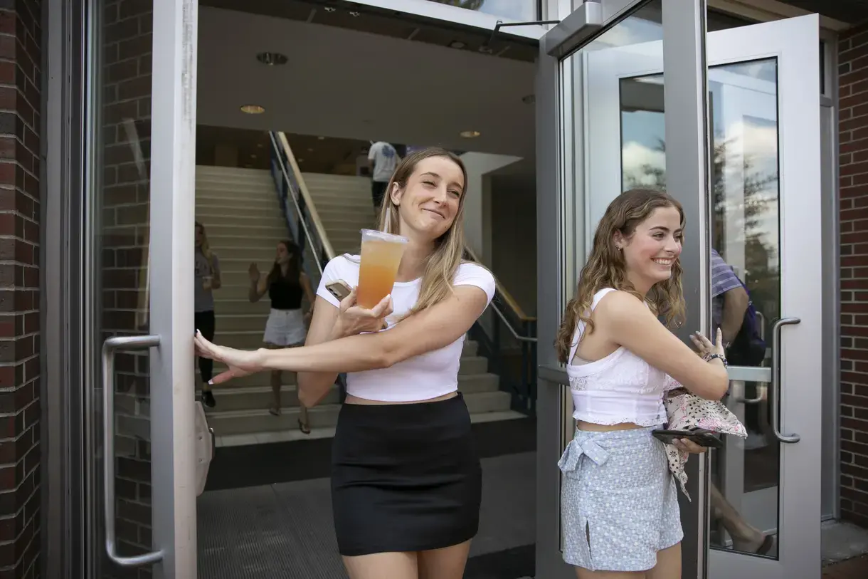 Two girls leaving Hogan campus center